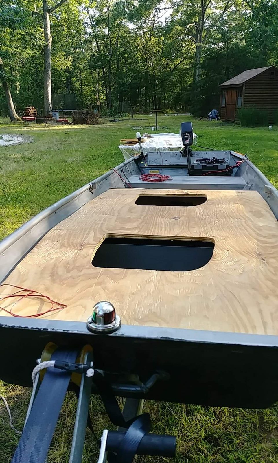 Plywood deck cutouts fitted in the backyard, shed visible behind